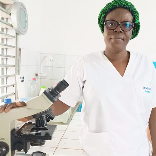 Handsome black young man dentist smiling over modern dental clinic background